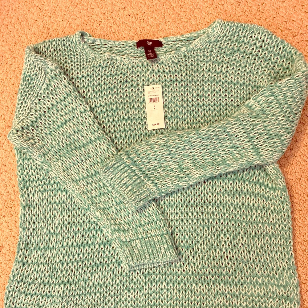 A soft jumper on the baggy side. Brand new. Small